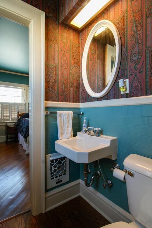 bathroom featuring hardwood / wood-style floors and toilet