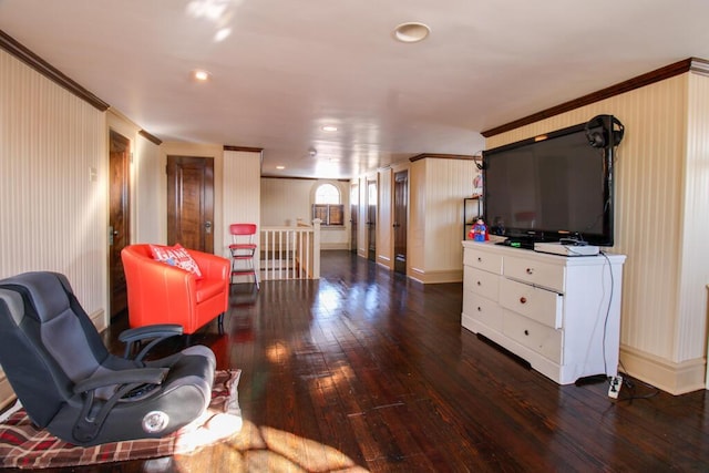 living room featuring dark hardwood / wood-style flooring and ornamental molding