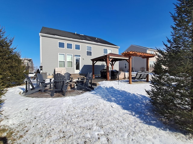 snow covered property with a pergola, a fire pit, and a gazebo