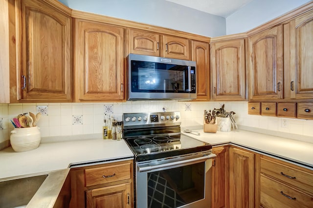 kitchen featuring stainless steel appliances and tasteful backsplash