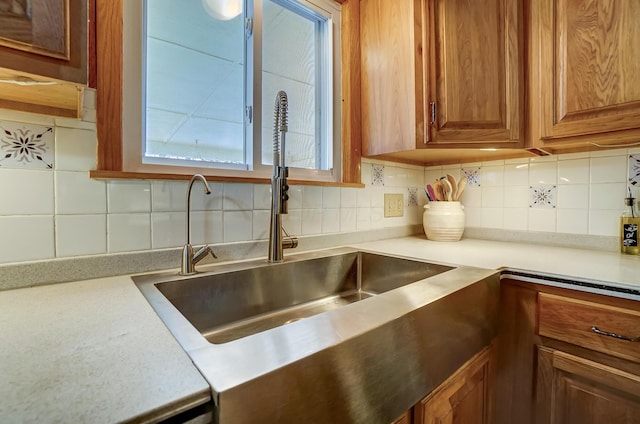 kitchen featuring tasteful backsplash and sink