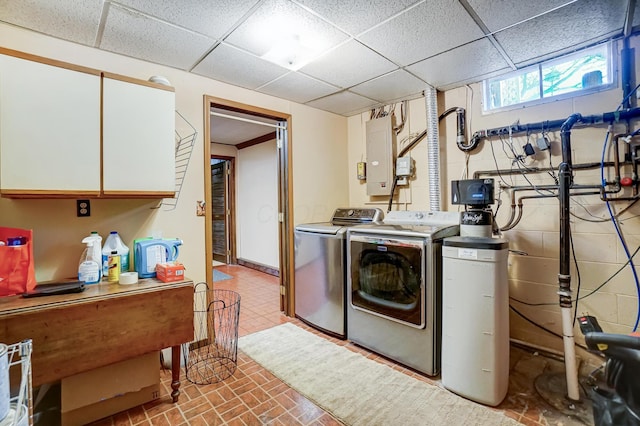 clothes washing area with cabinets, separate washer and dryer, and electric panel