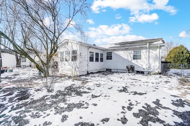 snow covered property featuring central AC