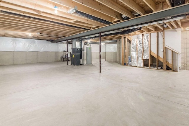 basement featuring heating unit and gas water heater