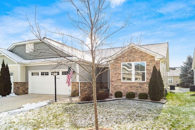 view of front of home with a garage and central AC unit