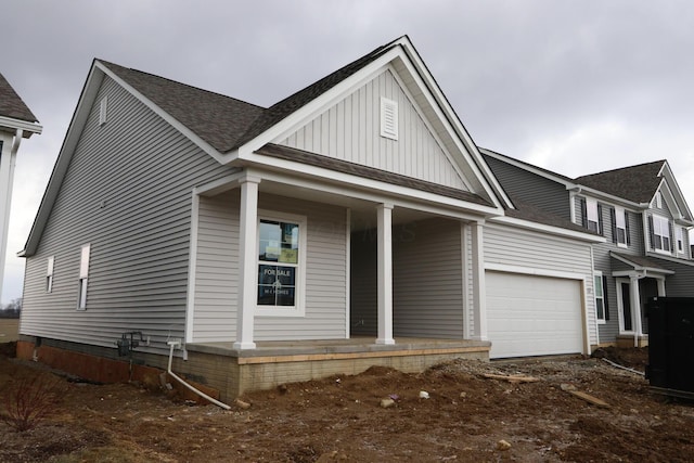 view of front of property featuring covered porch and a garage