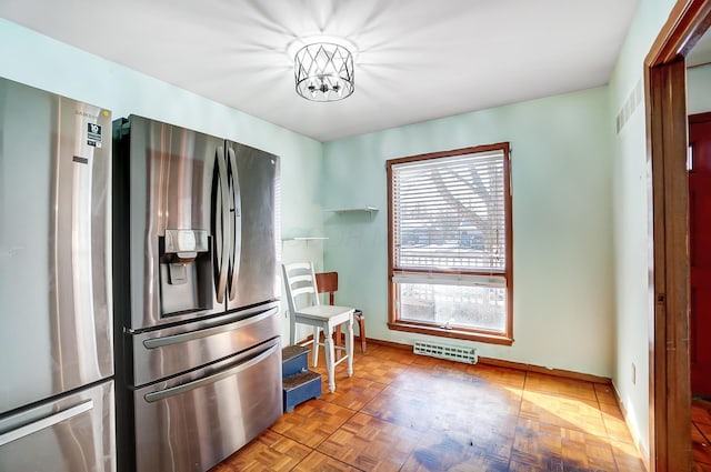 kitchen with stainless steel refrigerator, parquet flooring, stainless steel fridge, and a wealth of natural light