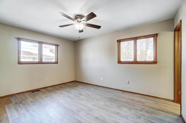 spare room featuring ceiling fan and light hardwood / wood-style floors