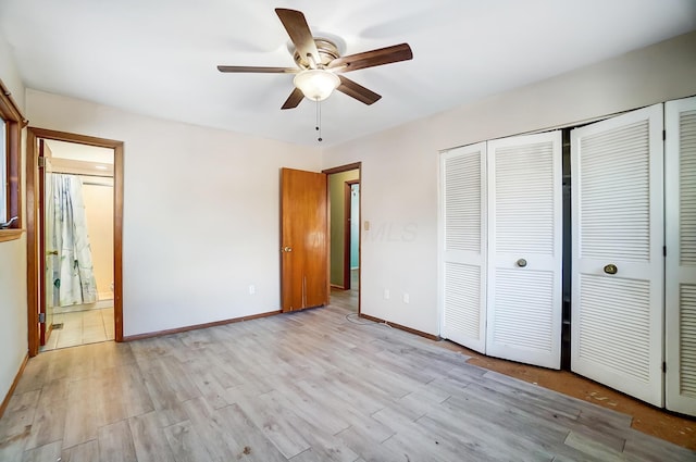 unfurnished bedroom with multiple closets, ensuite bath, light hardwood / wood-style floors, and ceiling fan