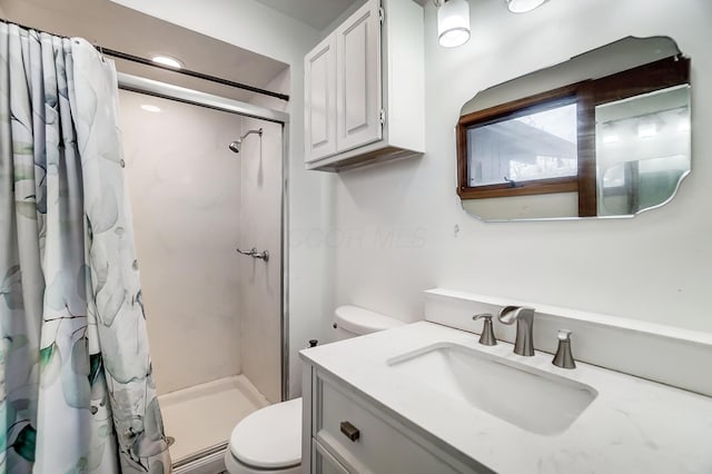 bathroom with vanity, toilet, and curtained shower