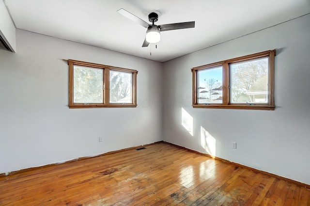 empty room featuring ceiling fan and light hardwood / wood-style flooring