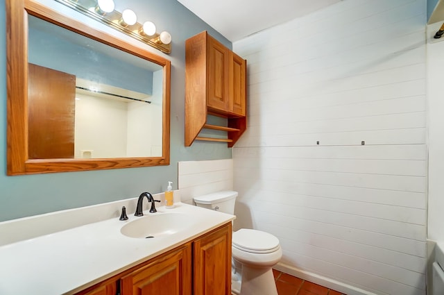 bathroom featuring tile patterned floors, vanity, and toilet