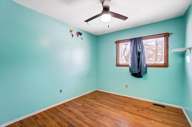 unfurnished room featuring hardwood / wood-style flooring and ceiling fan