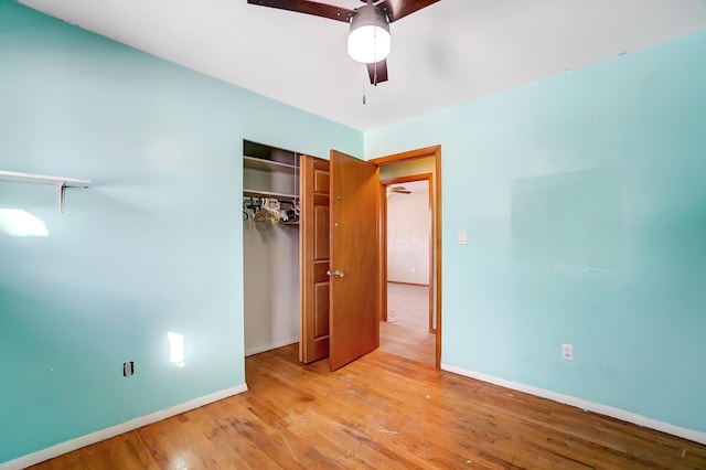 unfurnished bedroom featuring a closet, ceiling fan, and light wood-type flooring