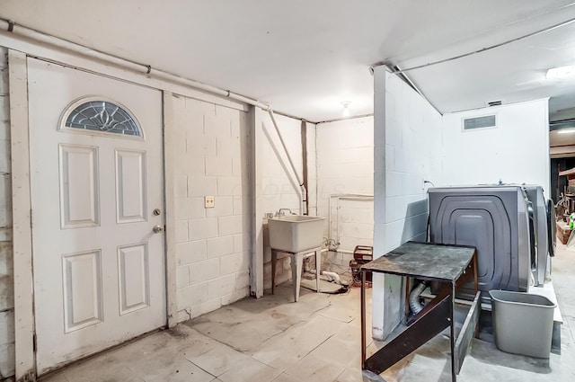 basement with washer / clothes dryer and sink