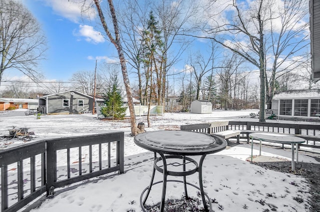 snow covered deck with a storage unit