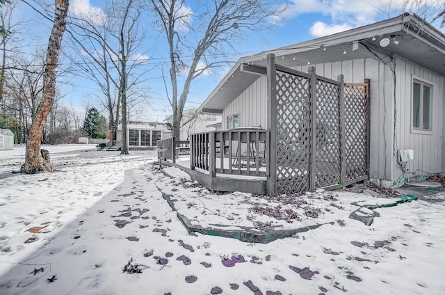 view of snow covered exterior featuring a deck