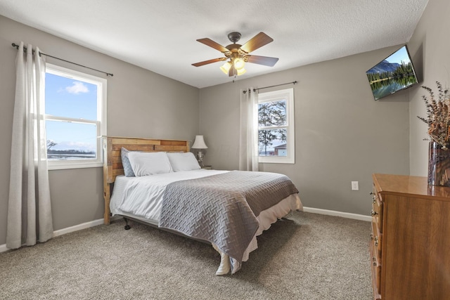 bedroom featuring multiple windows, light carpet, and ceiling fan