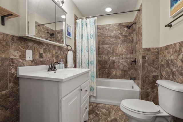 full bathroom with toilet, shower / tub combo, a textured ceiling, tile walls, and vanity