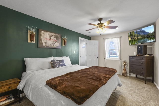 bedroom featuring carpet floors, a textured ceiling, and ceiling fan