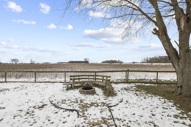 exterior space featuring a rural view and an outdoor fire pit