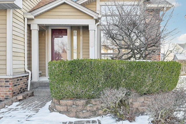 view of snow covered property entrance