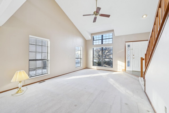 unfurnished living room featuring high vaulted ceiling, light carpet, and ceiling fan