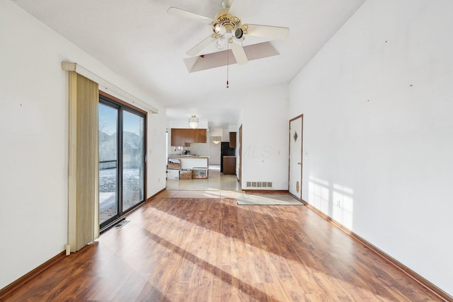 unfurnished living room with ceiling fan and light wood-type flooring