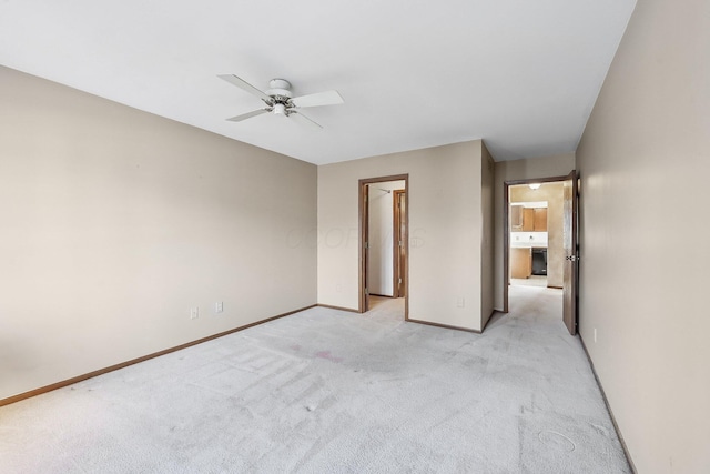 unfurnished bedroom with light colored carpet, a closet, and ceiling fan