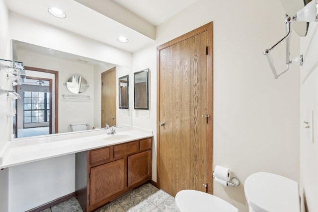 bathroom featuring toilet and vanity