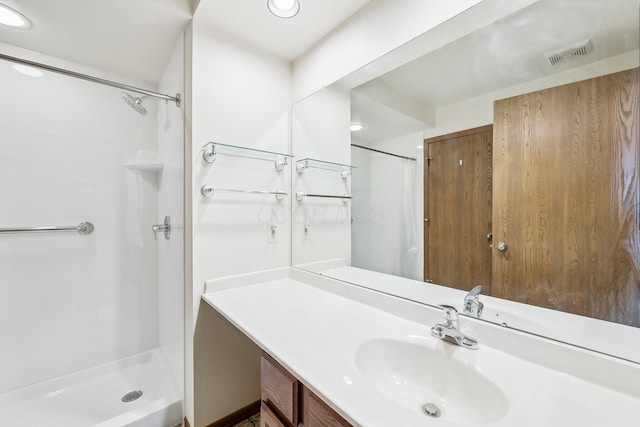 bathroom with a shower and vanity