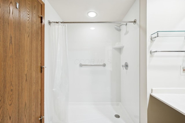 bathroom with a shower with curtain and vanity