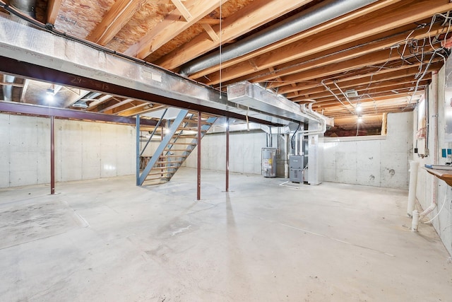 basement with water heater and heating unit