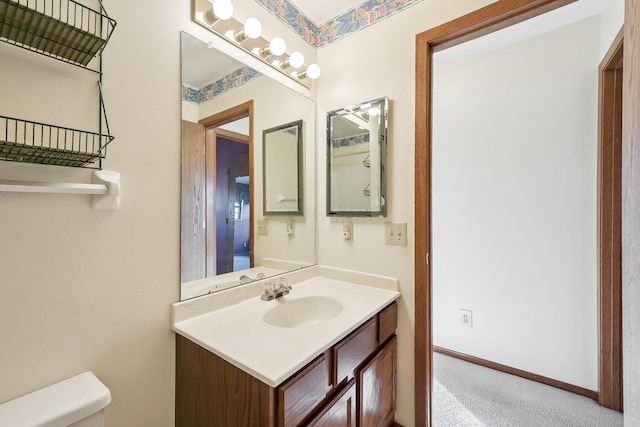 bathroom featuring toilet and vanity