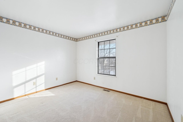 spare room with light colored carpet