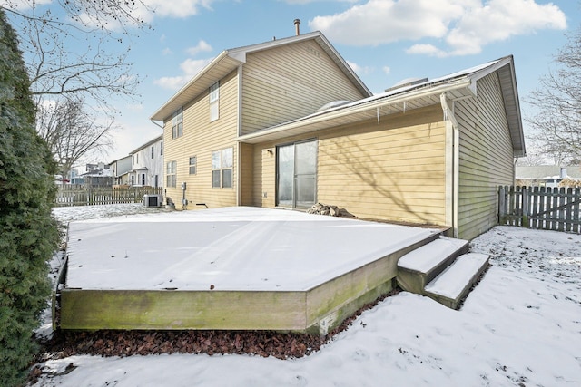 snow covered house with central AC