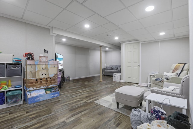 interior space with dark wood-type flooring and a drop ceiling