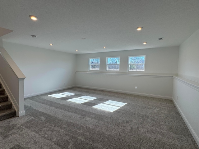 unfurnished room featuring stairway, recessed lighting, carpet flooring, and baseboards