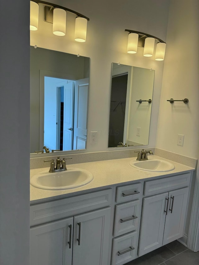 full bath with tile patterned flooring, a sink, and double vanity