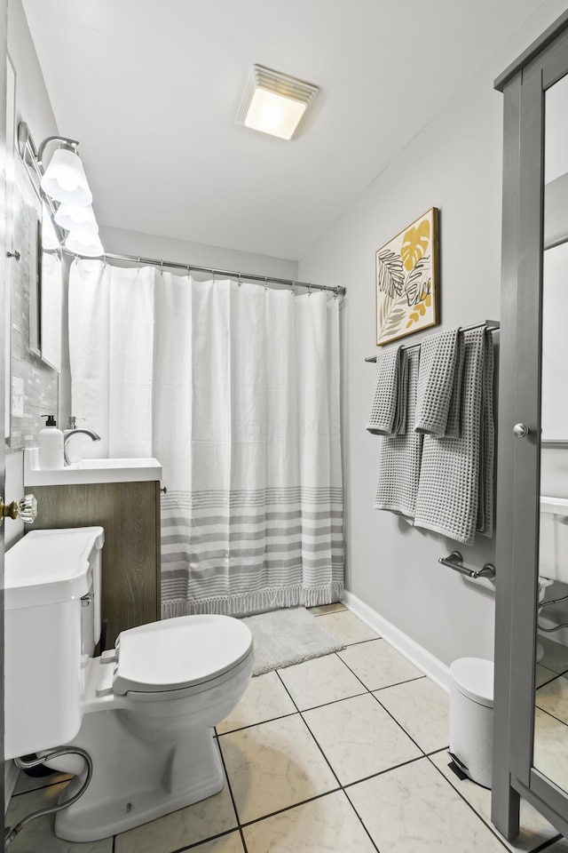 bathroom featuring tile patterned flooring, a shower with curtain, and toilet