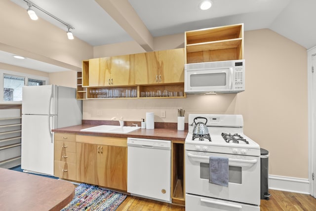 kitchen with sink, vaulted ceiling, light wood-type flooring, track lighting, and white appliances