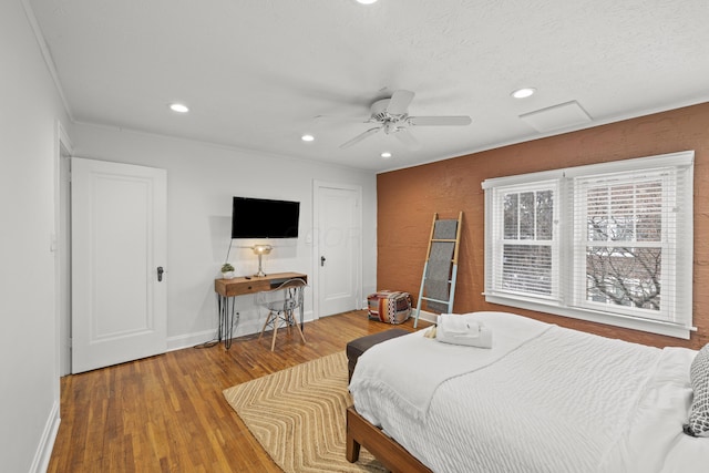 bedroom with ceiling fan and hardwood / wood-style floors