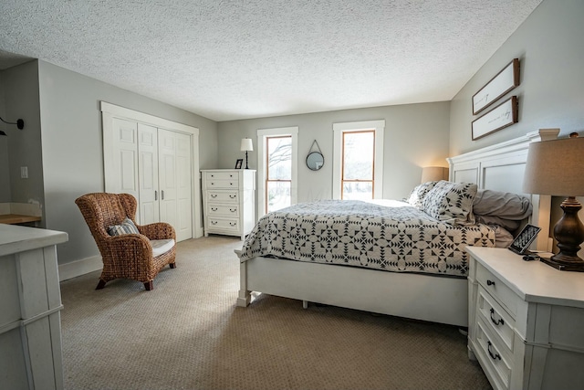 bedroom with a textured ceiling, a closet, and carpet