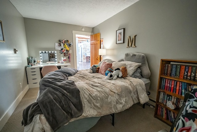 bedroom with a textured ceiling and light carpet