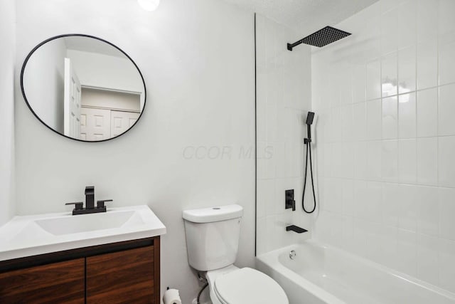 full bathroom featuring vanity, toilet, tiled shower / bath combo, and a textured ceiling