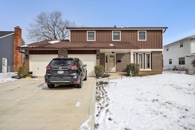 traditional-style house with driveway, an attached garage, board and batten siding, and brick siding