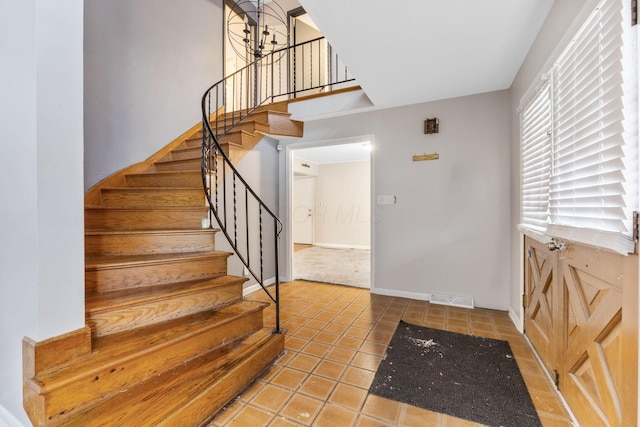 staircase featuring tile patterned floors