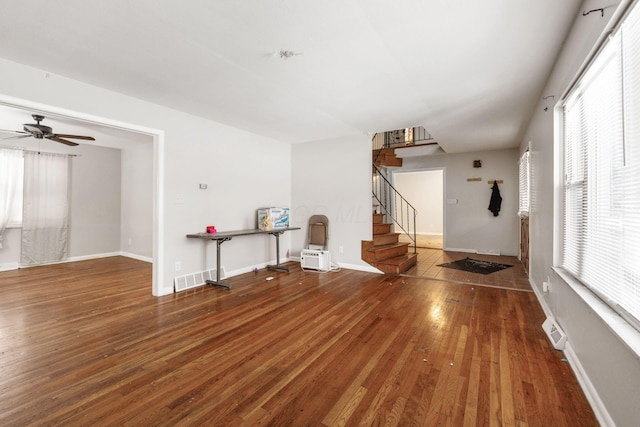 unfurnished living room featuring ceiling fan and hardwood / wood-style floors