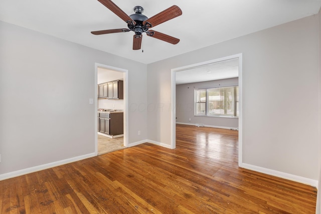 unfurnished room with ceiling fan and light hardwood / wood-style flooring