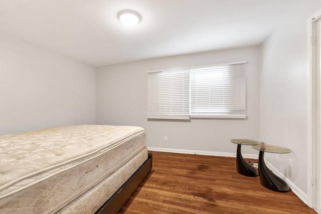 bedroom featuring dark hardwood / wood-style flooring